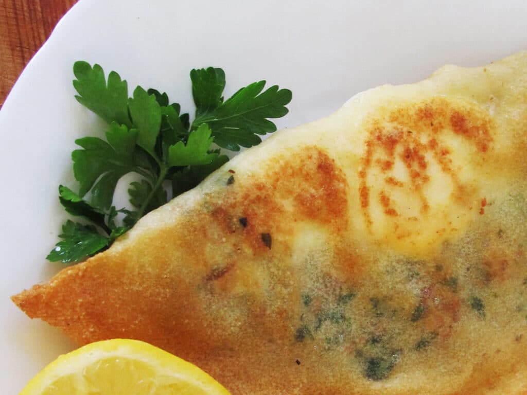 Tunisian traditional dish "brik". A whole egg in a deep fried pastry pocket with tuna and parsley.