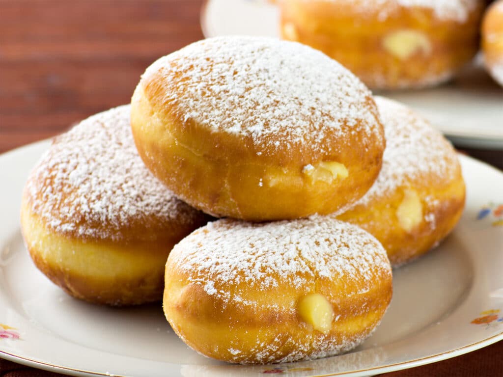 Sweet komemade krapfen pastry so called bomboloni, in Italy, (food -dessert) fullfilled wit a delicious cream.