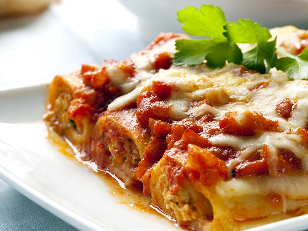 Cannelloni topped with melting cheeses, ready to enjoy.
