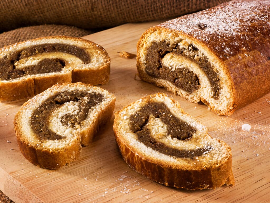 Traditional Hungarian folk cake xmas walnut rolls on a wooden cutting board
