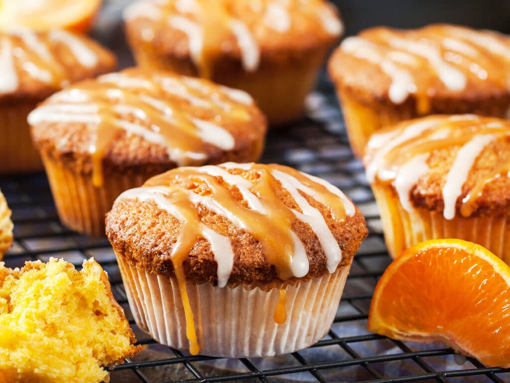 Carrot tangerine cupcakes decorated with glaze and caramel topping