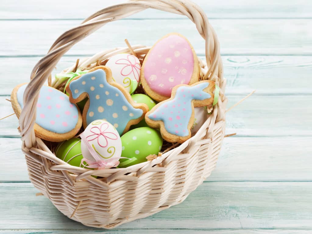 Easter gingerbread cookies on wooden table. Eggs and rabbits. With space for your greetings