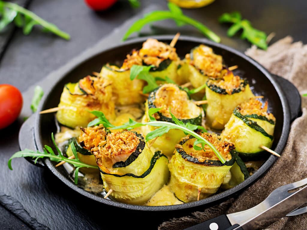 Baked zucchini rolls with cheese, carrot and chicken breast