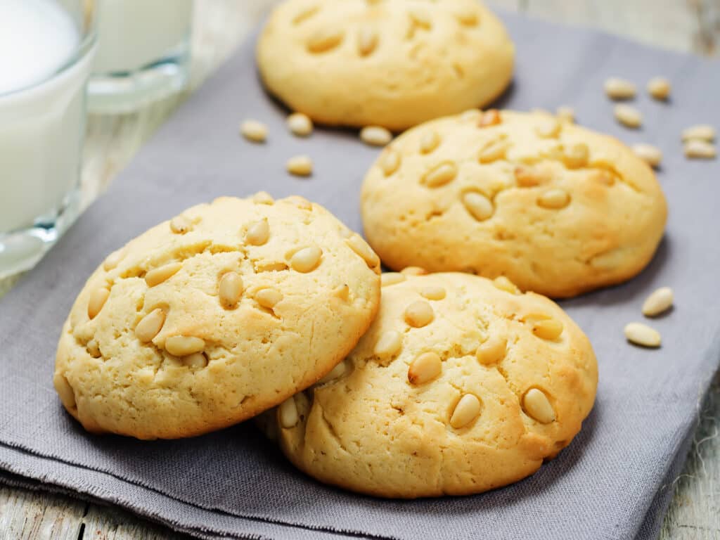 Pine nuts cookies with glasses of milk. Italian cuisine. toning. selective focus