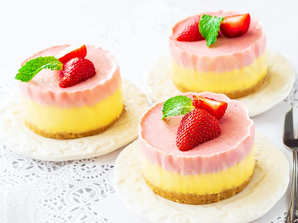 Delicious homemade mango strawberry cheesecake white background Copy space Selective focus.