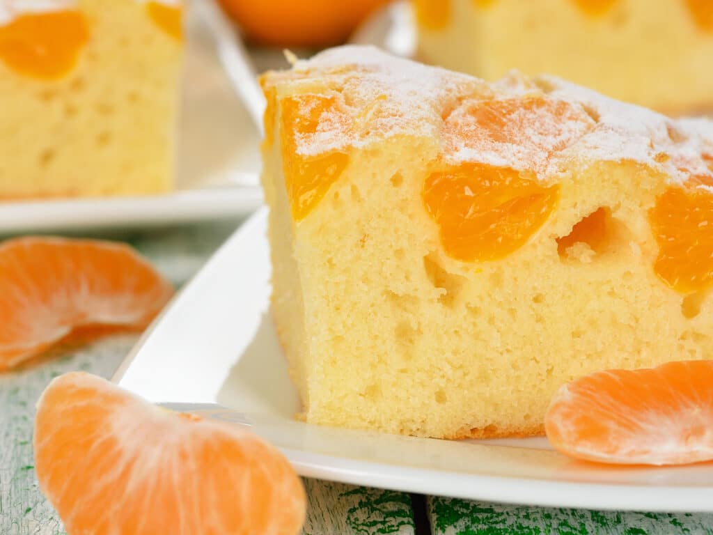 Cake with mandarin oranges on a white background