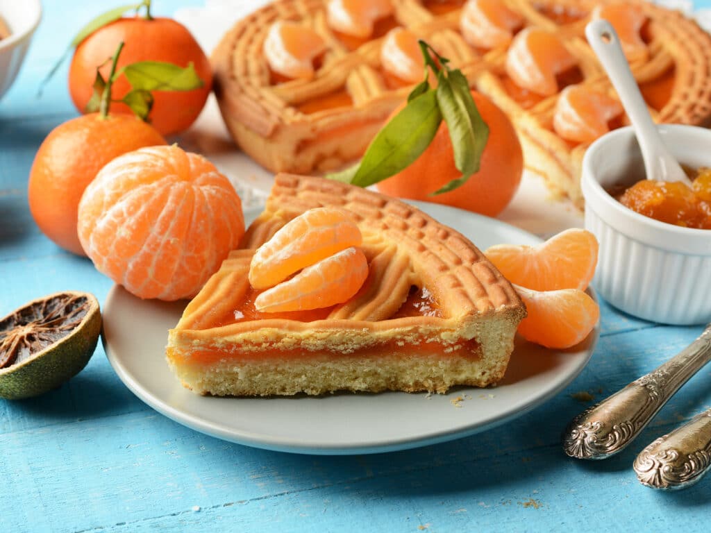 tangerine jam tart with ingredients around - closeup