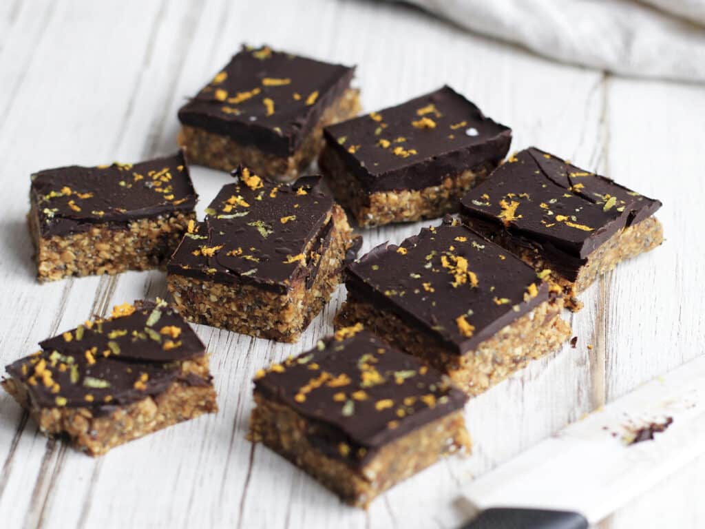 Raw Granola bar home made with peanuts, oats, dates and melted chocolate. Orange zest topping