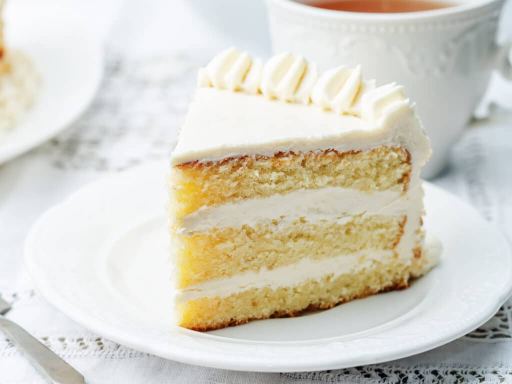 Sponge cake with butter cream on a white background. the toning. selective focus