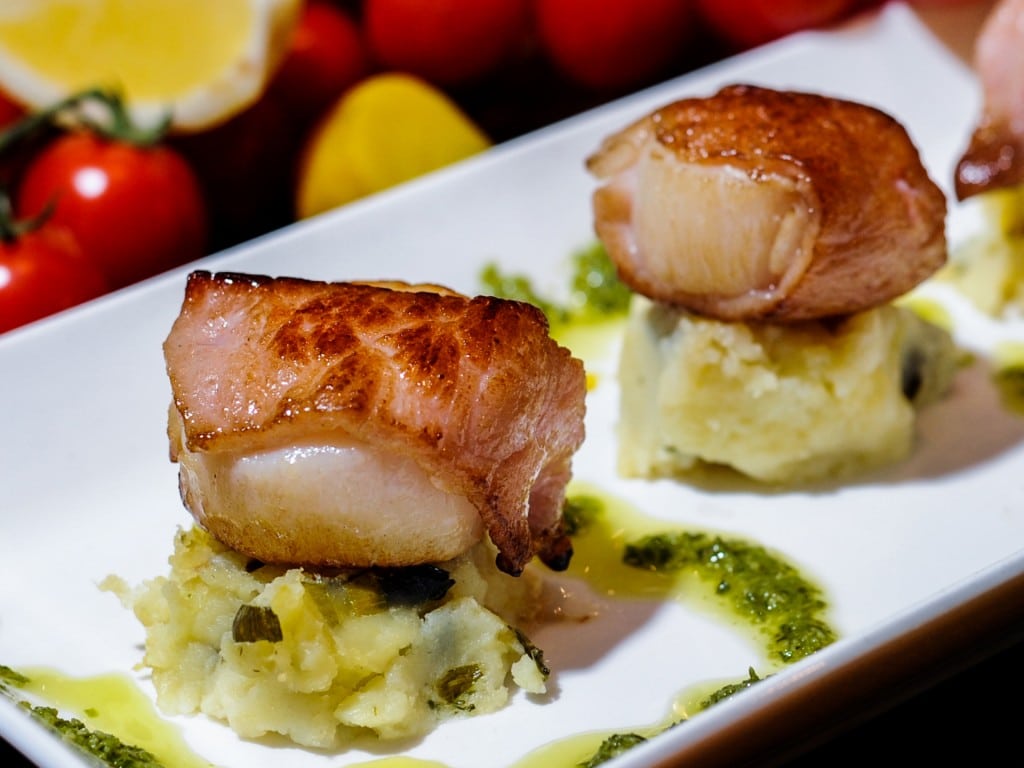 Seared scallops wrapped in panchetta, dill mouli mash and lemon curd drizzle