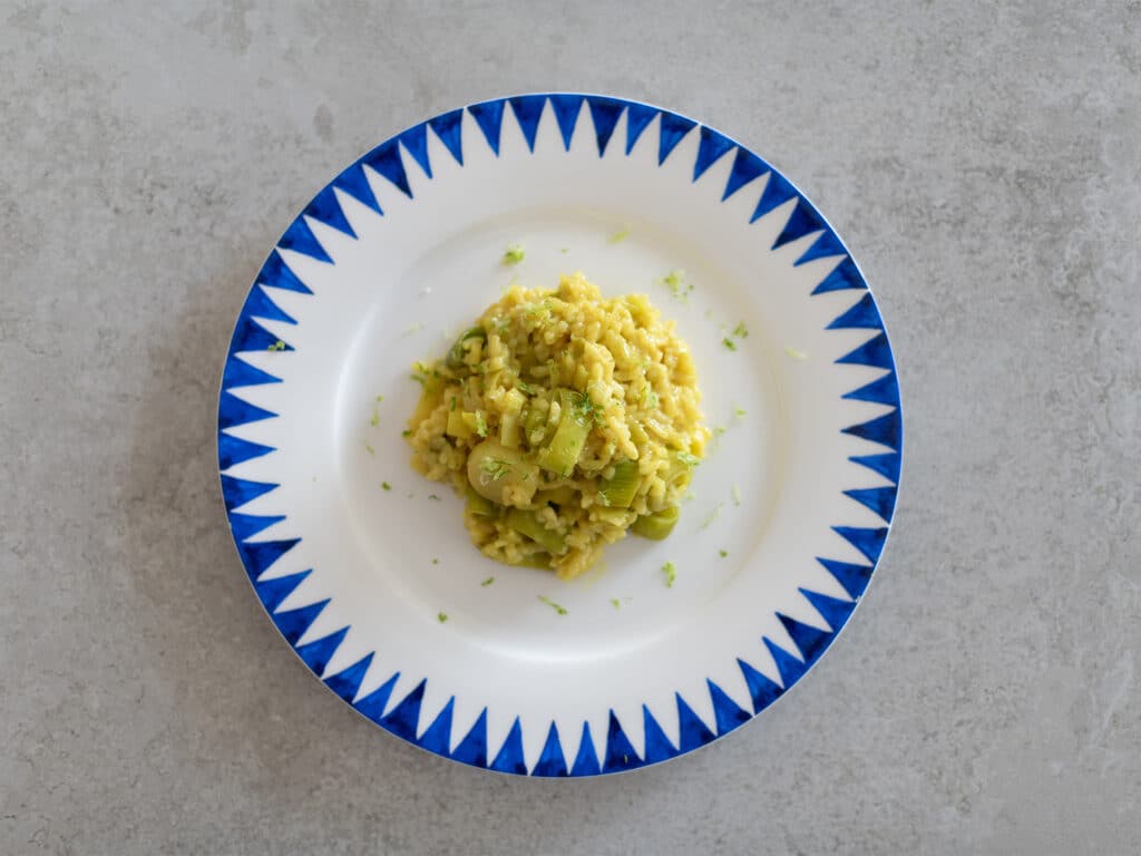 leek risotto with shredded lemon, served on a plate