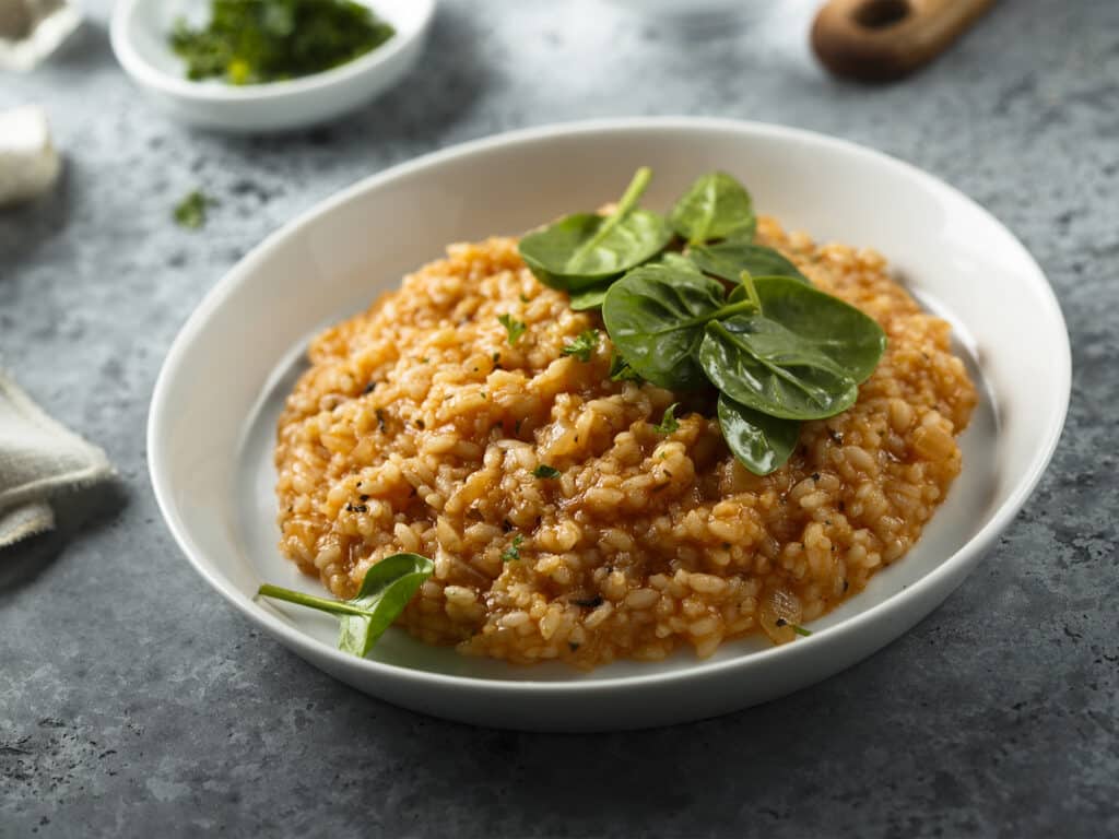 Homemade tomato risotto with fresh spinach
